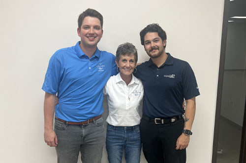 Three people taking a photo. Two from Collective Way one from Expo